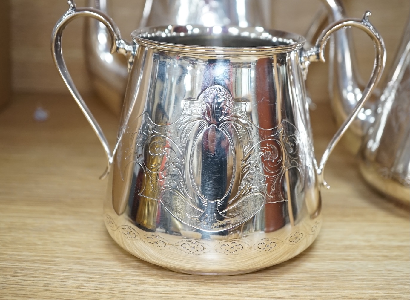 An Art Deco three piece silver brush set and a silver plated three piece tea set and miniature caldron, coffee pot 22cm high. Condition - fair